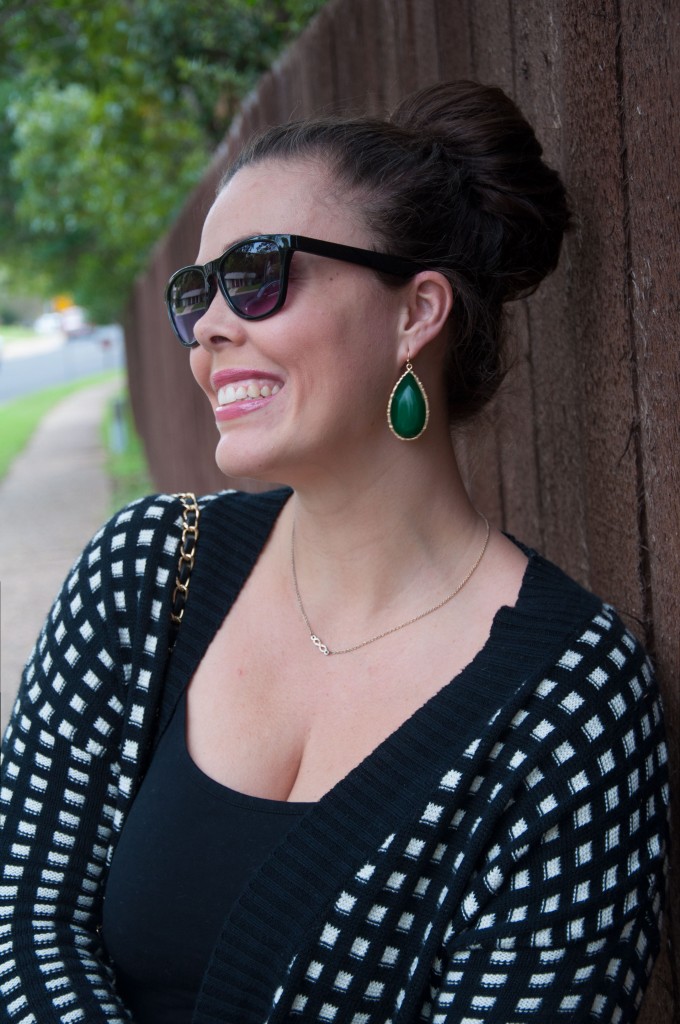 All That Glitters: Black and white sweater with emerald earrings