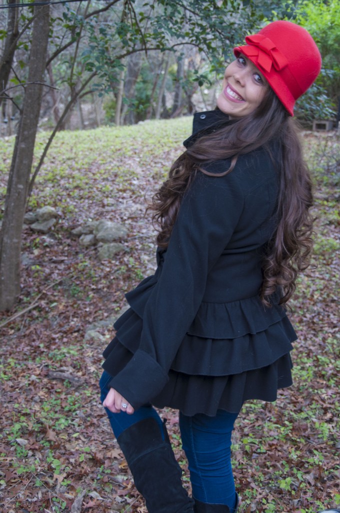 Red hat with a ruffly black coat