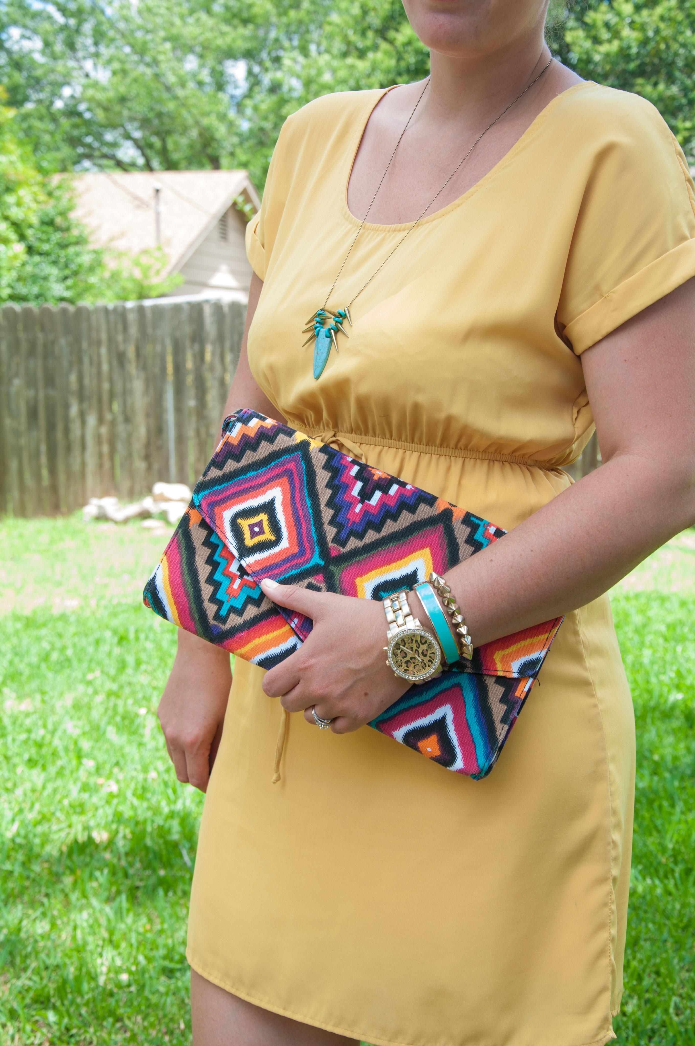 Yellow dress with aztec print clutch