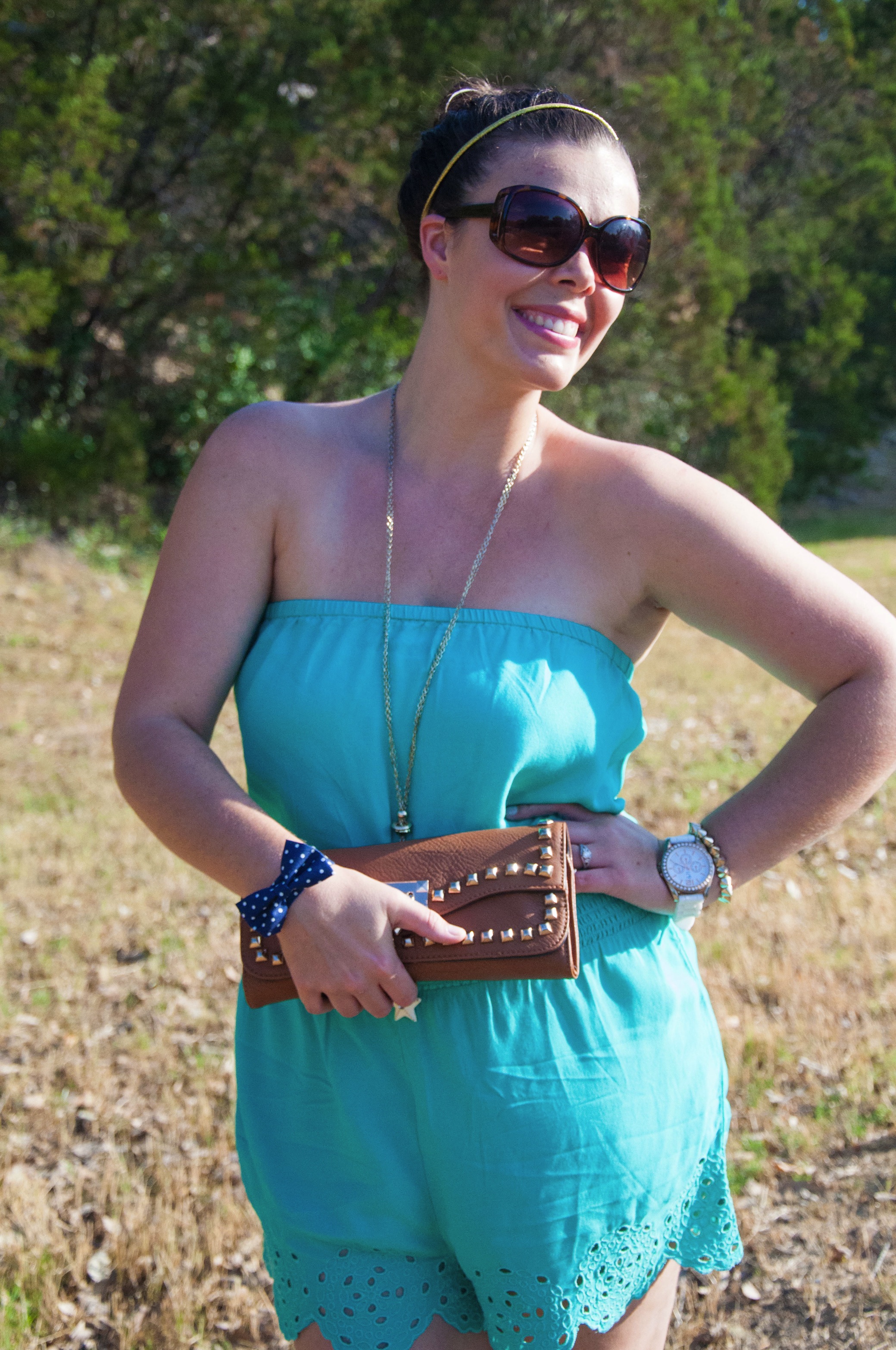 Turquoise romper with cognac clutch