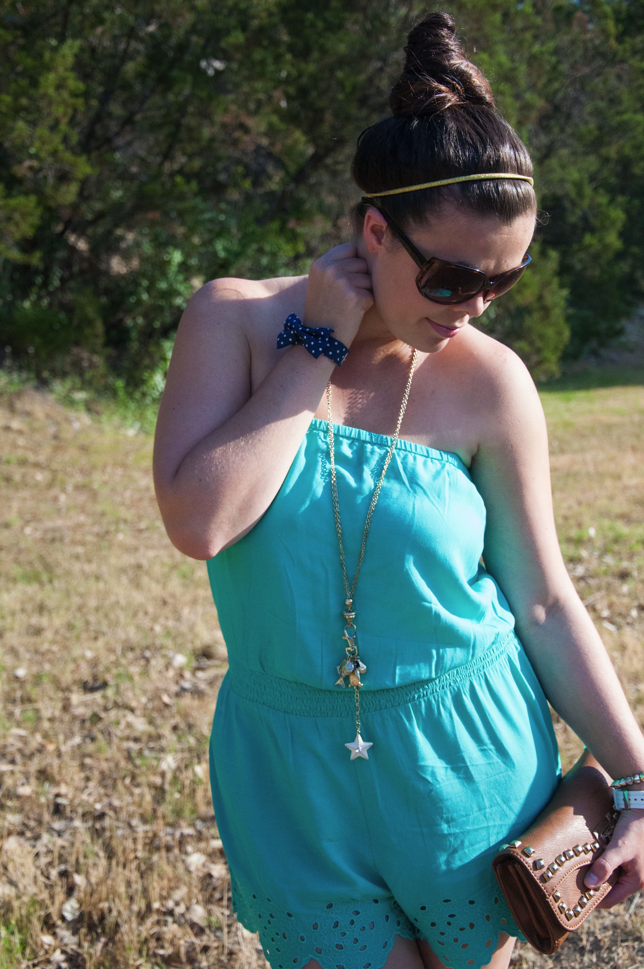 Turquoise romper with cognac clutch
