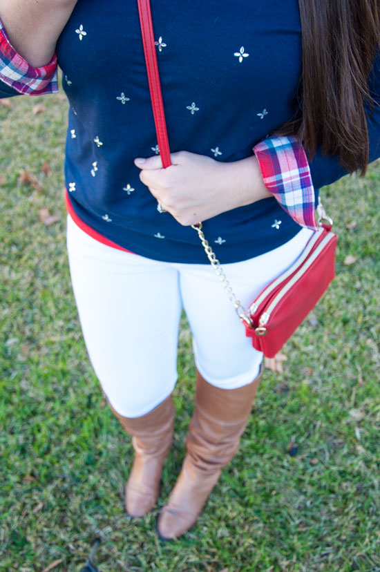 Navy jeweled sweater with white skinny jeans
