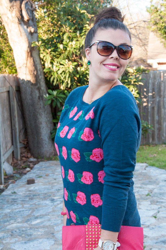 Rose sweater with pink clutch